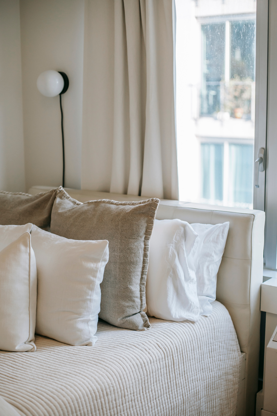 Bedroom interior with soft cushions on bed at home